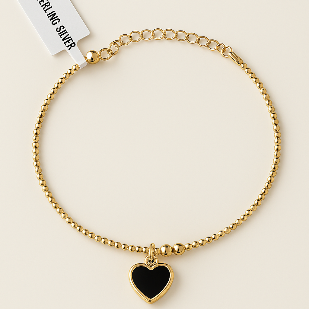 Gold beaded chain bracelet with black heart charm and adjustable clasp