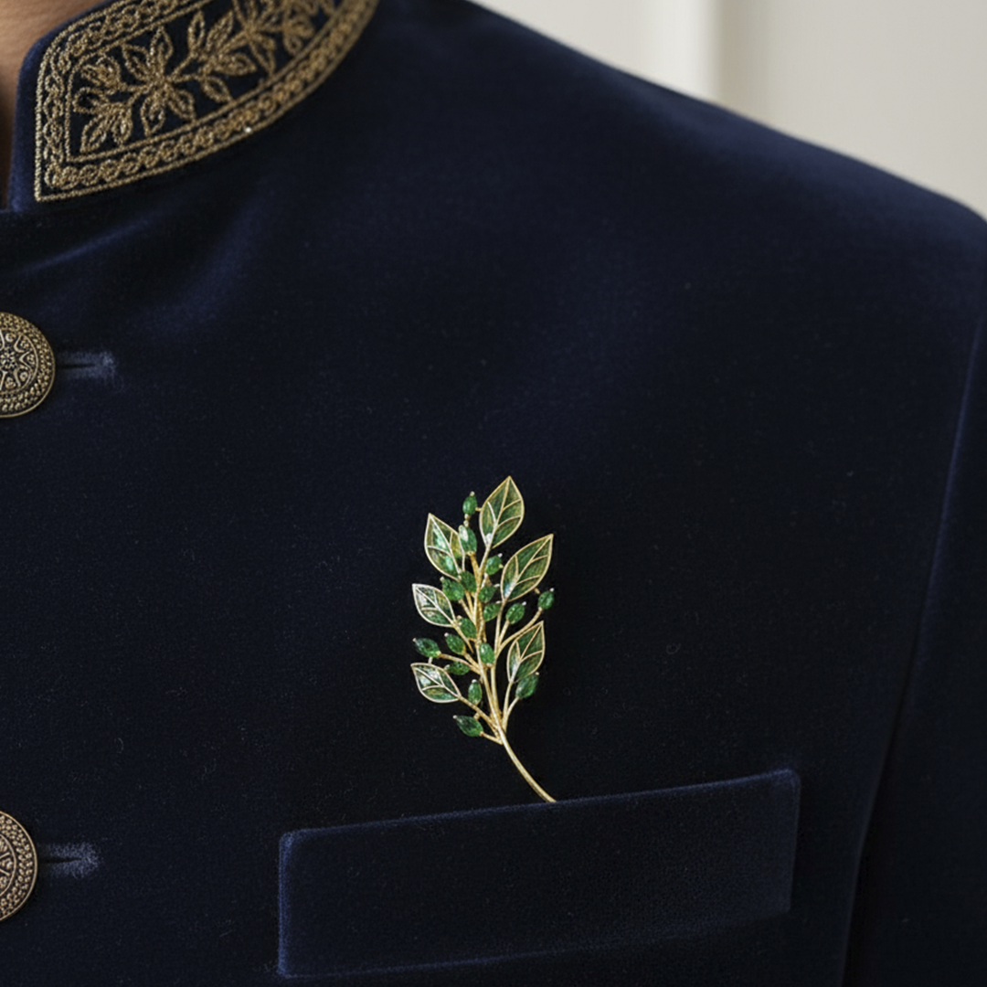 Navy blue velvet jacket with Aura Bling gold embroidery and a green leaf brooch.
