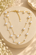 Pearl Grace Necklace with layered gold-tone chains and white pearl-like beads