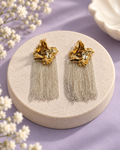 The Silverstream Drops with sculpted gold-tone tops and silver-tone chain tassels on a lilac background