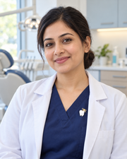 The Smile Signature Brooch worn as a small accent on a female dentist's navy scrubs
